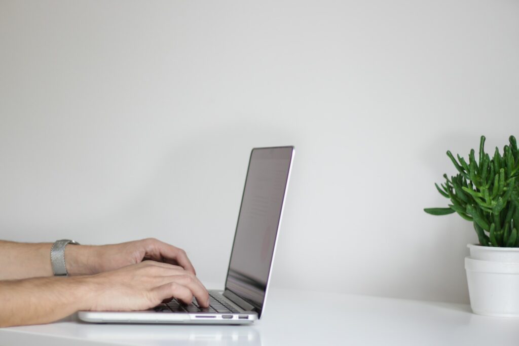 hand typing on computer